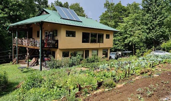 Solar-powered resilient home with terraced gardens at Earthaven Ecovillage