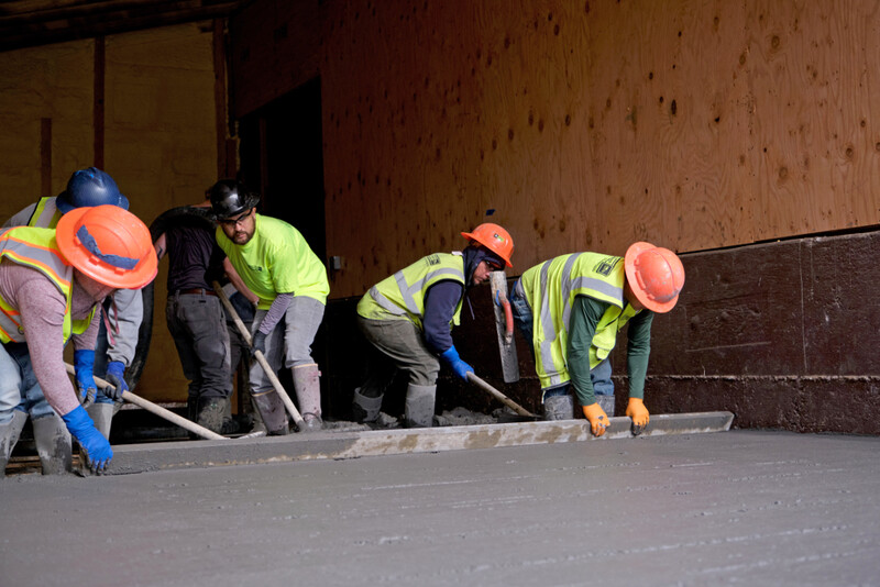  Contractors leveling concrete used in a floor slab.