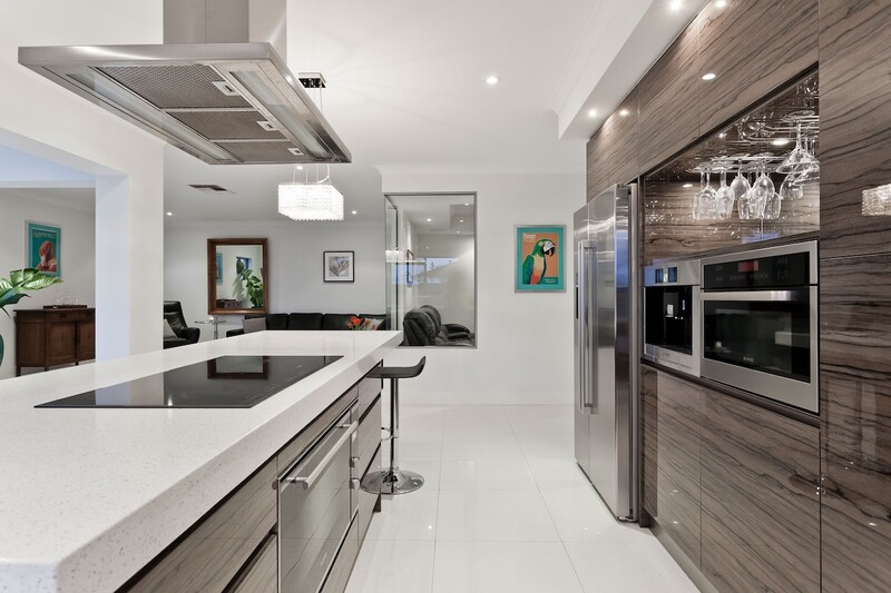 a large commercial kitchen with an island in shades of gray and brown.