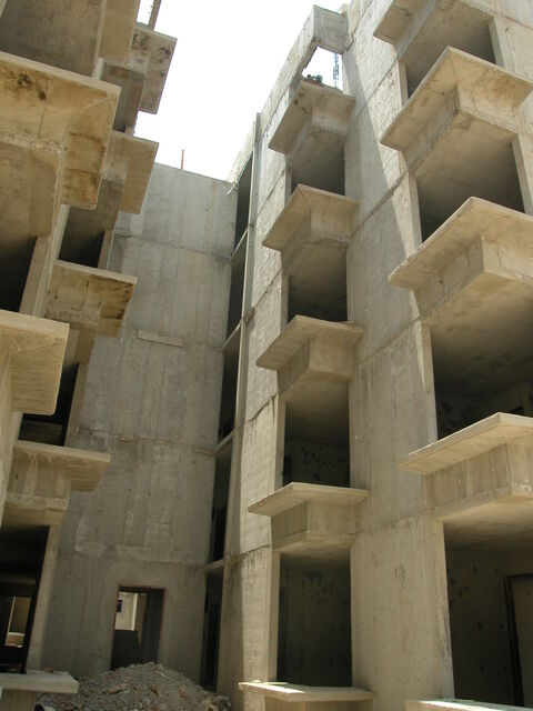  A mid-rise building with floor plates and structural columns made out of concrete. 