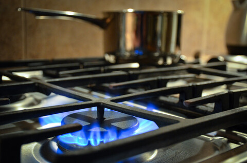  a gas stove with one burner lit