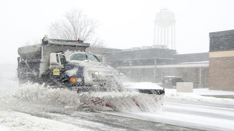 A dump truck snow plow clears snow from Purple Heart Drive during a snow storm March 5, 2015, on Dover Air Force Base, Delaware. 